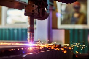 CNC laser plasma. Selective focus on modern technology laser plasma cutting of metal in process